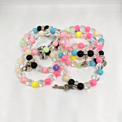 Colorful Bracelet with key-shaped charm on a white background
