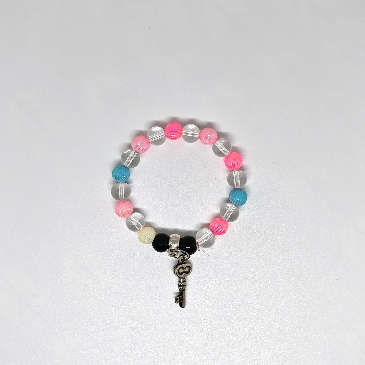 Colorful Bracelet with key-shaped charm on a white background