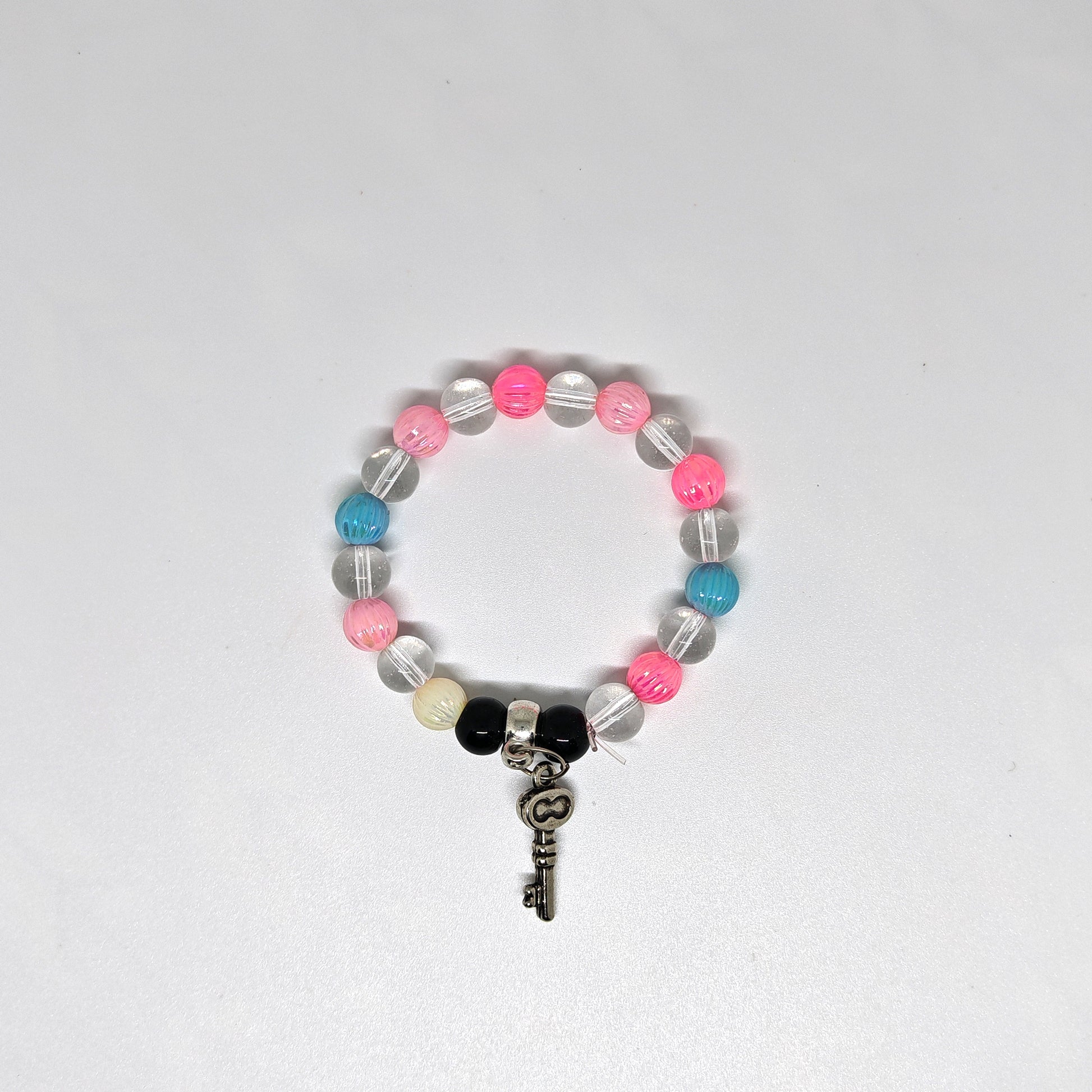 Colorful Bracelet with key-shaped charm on a white background