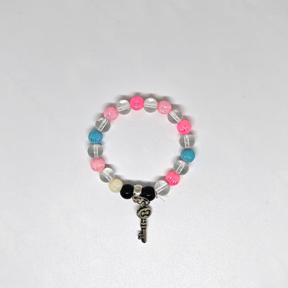 Colorful Bracelet with key-shaped charm on a white background